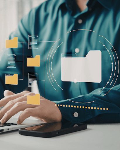 Business professional managing digital files on a laptop.