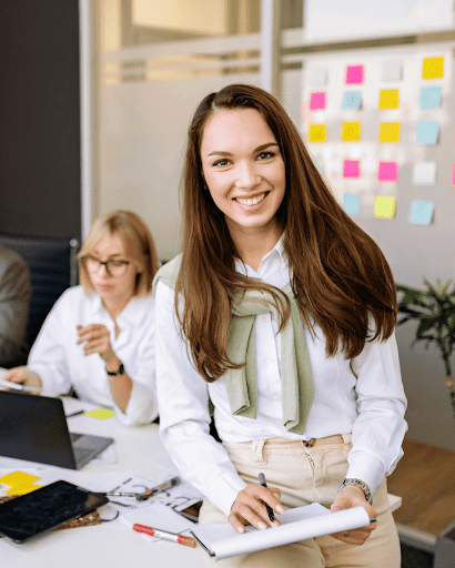 Smiling business professional in a modern office workspace.