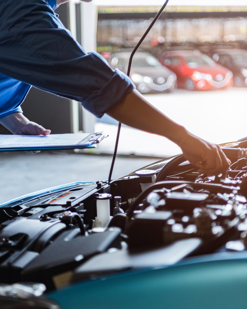 Mechanic working under the hood of a car.