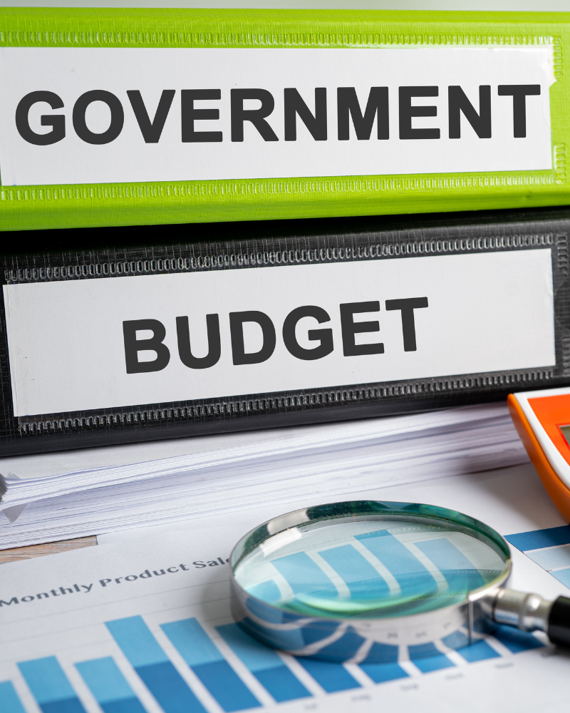 Government and budget binders sitting on a desk.