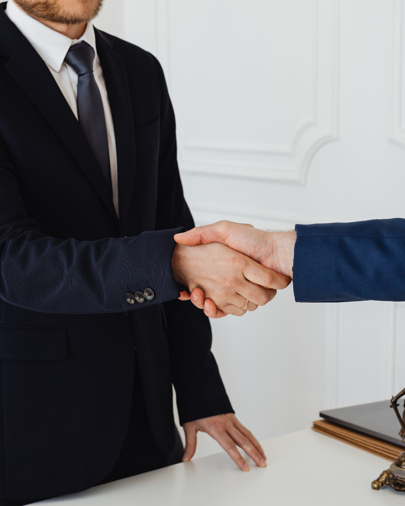 Two government professionals shaking hands.